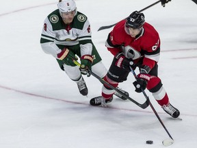 Ottawa Senators Tyler Ennis keeps the puck away from Minnesota Wild Ryan Donato during NHL action at the Canadian Tire Centre  on Monday.