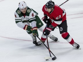 Ottawa Senators Tyler Ennis keeps the puck away from Minnesota Wild Ryan Donato during NHL action at thew Canadian Tire Centre on Monday.