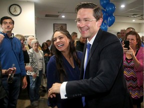 Conservative incumbent Pierre Poilievre arrives with his wife, Anaida, to applause from supporters at the Legion in Manotick after holding onto his seat in the Carleton riding  Tuesday night.