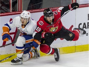 The Senators' Scott Sabourin, right, collides with the Islanders' Matthew Barzal during a game at Canadian Tire Centre on Oct. 25, 2019.