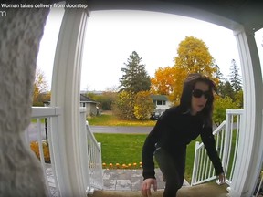 Screen capture from YouTube video showing a woman caught on camera taking an Amazon delivery from doorstep
