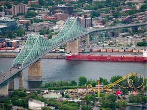 (FILES) In this file photo taken on June 21, 2019 an aerial photo of the Jacques Cartier Bridge is viewed in Montreal, Quebec, Canada. - Three Extinction Rebellion protestors were arrested October 8, 2019 after climbing the Jacques Cartier bridge -- a main link to the island city of Montreal -- to decry climate inaction, police said.