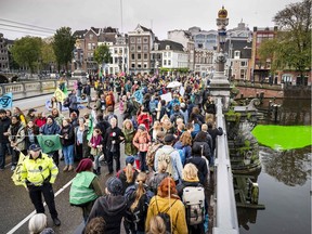 Activists from the "Extinction Rebellion" climate change action group block the Blauwbrug bridge on October 12, 219, in Amsterdam.