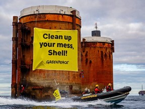 Greenpeace activists hung banners saying, 'Shell, clean up your mess!' and 'Stop Ocean Pollution' in a peaceful protest against plans by the company to leave parts of old oil structures with 11,000 tons of oil in the North Sea.