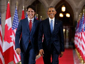 In this file photo taken on June 29, 2016, Justin Trudeau and then-US President Barack Obama walk through the Hall of Honour on Parliament Hill. Obama weighed in on Canada's election this week.