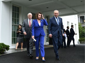 Speaker of the House Nancy Pelosi (C), Senate Minority Leader Chuck Schumer (D-NY) (R) and Representative Steny Hoyer, walk out of the White House after meeting with US President Donald Trump in Washington, DC on October 16, 2019.