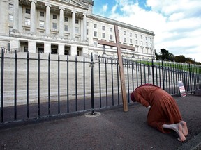 An anti-abortion activist poses for a photograph whilst demonstrating outside of Parliament Buildings, the seat of the Northern Ireland Assembly, on the Stormont Estate in Belfast, Northern Ireland, on October 21, 2019, as a number of lawmakers returned to attend a special sitting. -