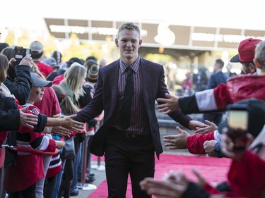 Brady Tkachuk greets fans as he walks the red carpet.