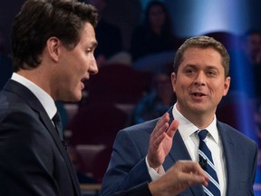 Conservative leader Andrew Scheer (R) and Canadian Prime Minister and Liberal leader Justin Trudeau debate a point during the Federal Leaders Debate at the Canadian Museum of History in Gatineau, Quebec on October 7, 2019.