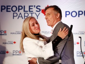 People's Party of Canada leader Maxime Bernier embraces with wife Christine Letarte after the announcement of federal election results in Beauceville, Quebec, Canada October 21, 2019.