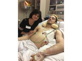 Saskatchewan nurse Vivian York, visits Broncos player Ryan Straschnitzki in a Saskatoon hospital in April, 2018 as shown in this image provided by Ryan's father Tom Straschnitzki. York was the first person at the scene of the crash which killed 16 people and injured 13 others, including Straschnitzki.