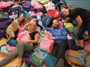 With help from Westgate Shopping Centre, last year the Caring and Sharing Exchange prepared over 3,300 backpacks for youngsters in need. Caring and Sharing Exchange members, from left: Christina Holmes, member of the board of directors; Cindy Smith, executive director; Derek Dedman, president of the board of directors; Sharon Lloyd, member of the board of directors.