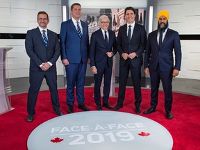 Bloc Quebecois leader Yves-François Blanchet, Conservative leader Andrew Scheer, TVA network host Pierre Bruneau, Liberal leader and Prime Minister Justin Trudeau and NDP leader Jagmeet Singh pose before a French language debate for the 2019 federal election at TVA studios in Montreal, Quebec, Canada Oct. 2, 2019.