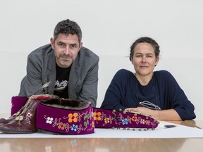 Greg A. Hill, curator, and Rachelle Dickenson, curator, with work by artist Barry Ace entitled "Nigik Makisinian-Otter Moccasins", 2014, National Gallery of Canada.