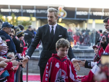 Ottawa Senators Anders Nilsson greets fans as he walks the red carpet.