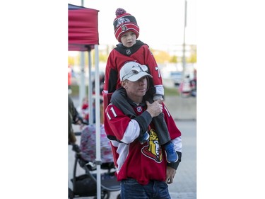 Scott Cole and five-year-old son Cameron on their way in to the CTC for the Ottawa Senators home opener against the New York Rangers.