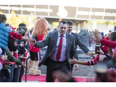 Head coach D.J. Smith greets fans as he walks the red carpet.