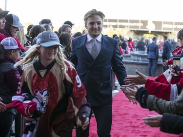 Erik Brannstrom greets fans as he walks the red carpet.