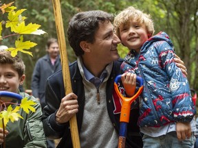Federal Liberal leader Justin Trudeau plants a tree with his sons Hadrien (right) and Xavier at the Frank Conservation Area in Plainfield, Ont. on Sunday, October 6, 2019.
