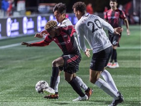 Ottawa Fury FC's Christiano François works against A. J. Paterson and another Charleston opponent at TD Place stadium on Wednesday, Oct. 23, 2019.