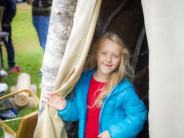 Anishinabe Nibin, or "Algonquin summer," was celebrated in Gatineau Park on Saturday, Oct. 12, 2019, where people could learn more about the traditional Algonquin way of life, as well as a chance to see artisans at work. Six-year-old Zoé Delarosbil-Proulx checks out the birchbark wigwam.   Ashley Fraser/Postmedia