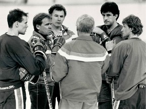 A file photo of an on-ice discussion during an Edmonton Oilers practice in May 1984, including, left to right, Mark Messier, head coach and general  manager Glen Sather, assistant coaches Ted Green and John Muckler (back to camera), Jaroslav Pouzar and Wayne Gretzky.