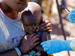 A child reacts as a health worker injects her with the Ebola vaccine, in Goma, Democratic Republic of Congo, August 5, 2019.