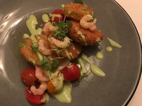 Fried green tomatoes with chèvre, pickled Matane shrimp, cherry tomato confit, sheep milk and herb vinaigrette served at Beckta.