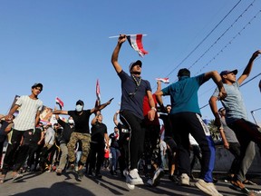 Demonstrators shout slogans and dance during a protest over corruption, lack of jobs, and poor services, in Baghdad, Iraq October 26, 2019.