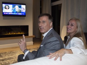People's Party of Canada Leader Maxime Bernier and his wife Catherine Letarte watches elections results on television Monday, October 21, 2019 in Beauceville, Que. Canadians are going to the polls in a general election.