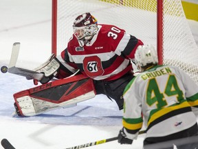 67's netminder Cédrick Andrée makes a save in front of the Knights' Jonathan Gruden during Friday night's contest in London, Ont.