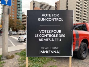 Catherine McKenna has new lawn signs that break from party tradition.