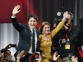 Liberal leader Justin Trudeau and wife Sophie Gregoire Trudeau wave as they go on stage at Liberal election headquarters in Montreal, Monday, Oct. 21, 2019.