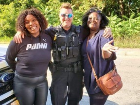 Const. Andrea Cohen, centre, with two tourists who ran out of gas last month.