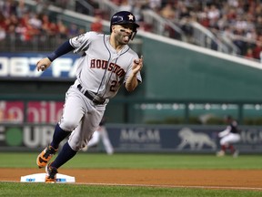 Jose Altuve #27 of the Houston Astros rounds third base and scores a run on a hit by Alex Bregman against the Washington Nationals during the first inning in Game Four of the 2019 World Series at Nationals Park on October 26, 2019 in Washington, DC.