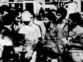 This file photo shows a U.S. hostage (blindfolded) being paraded by his captors in the compound of the U.S. Embassy Tehran, Iran.