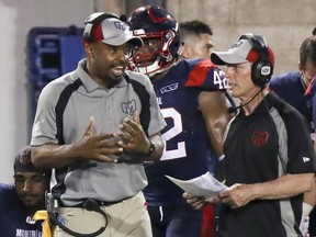 Montreal Alouettes head coach Khari Jones, left, has a conversation with defensive coordinator Bob Slowik during a game against the Hamilton Tiger-Cats in Montreal on July 4, 2019.