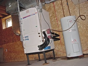 Upgrading an old furnace can lead to energy savings of hundreds of dollars a year. This forced-air natural gas furnace is also connected to central air conditioning.