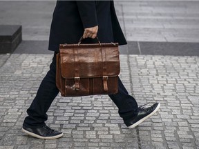 A file image of a man walking along a street in New York.