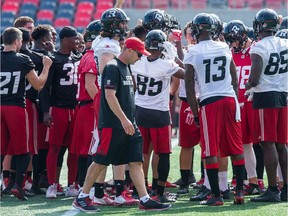 Coach Rick Campbell walks past the team as the Ottawa Redblacks practice at TD Place.