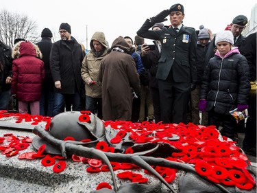 A member of the Canadian Forces salutes after laying her poppy on the Canadian Tomb of the Unknown Soldier at the National War Memorial in Ottawa following Remembrance Day ceremonies. November 11, 2019. Errol McGihon/Postmedia