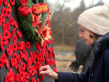 People lined up to place their poppies around a wreath following the Remembrance Day ceremony at the Manotick Monday (Nov. 11, 2019).