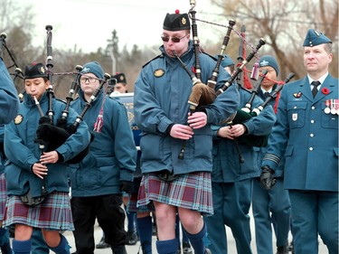 A bagpiper with bright red knees from the cold leads the parade past the Manotick Cenotaph for Remembrance Day Monday (Nov. 11, 2019).
