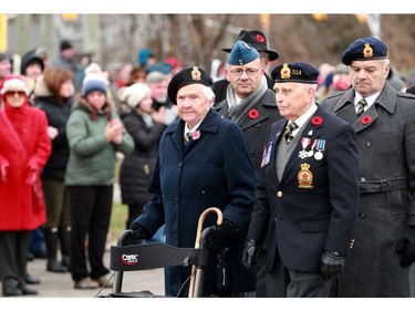Hundreds of people clap  as the veterans make their way past the Manotick Cenotaph for Remembrance Day Monday (Nov. 11, 2019).