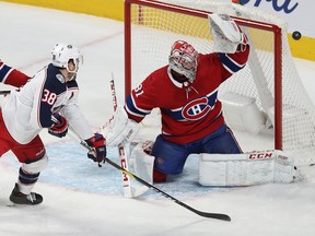 Canadiens goaltender Carey Price deflects the shot of Blue Jackets' Boone Jenner past the net during first-period action at the Bell Centre Tuesday night.