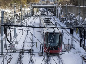 A LRT train makes its way out of Tunney's Pasture Station in Ottawa after the first significant snowfall of the season. November 12, 2019.