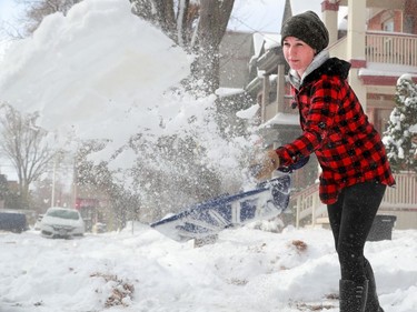 Dee MacLennan puts her back into it, clearing her driveway on Regent Street following the wallop of snow overnight that left Ottawans shovelling and digging out their cars Tuesday morning.