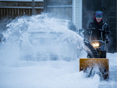 Ian MacNeil snowblows a neighbour's driveway after the first significant snowfall of the season in Ottawa. November 12, 2019.