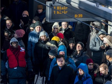 Ottawa residents deal with record low temperatures as they wait for a train at Tunney's Pasture Station. November 13, 2019.