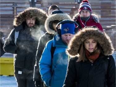 Ottawa residents deal with record low temperatures on their way to work at Tunney's Pasture. November 13, 2019.